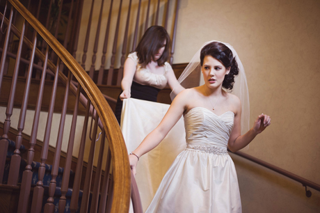 Groom Holding Bride's Wedding Dress Train