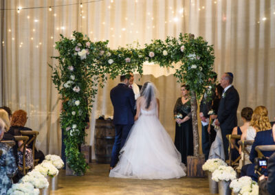 bride and groom stand under chuppah at Atlanta wedding ceremony