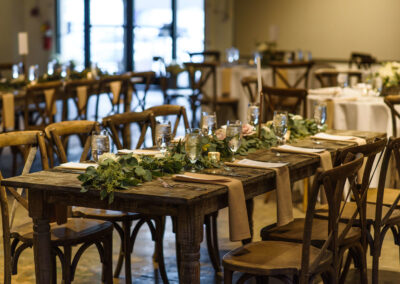 rustic wood farm tables at indoor wedding reception in Atlanta